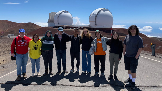 Students in front of telescope observatories