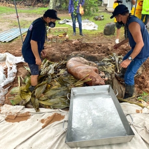 people preparing a pig