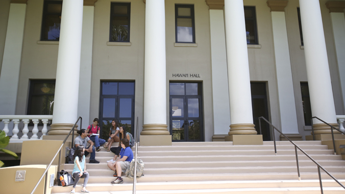 people sitting on steps of a building