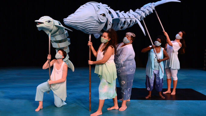 people holding up puppets