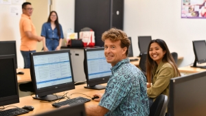 People smiling at computers