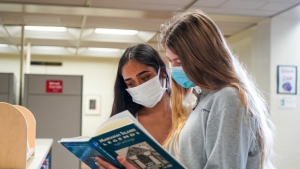 Two students looking at a book