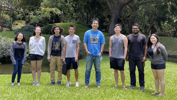 people standing on grass smiling at the camera