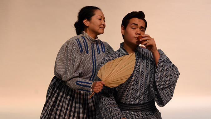 Man drinking sake and woman with a fan