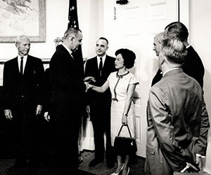 woman shaking hands with president