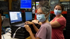 people repairing laptops