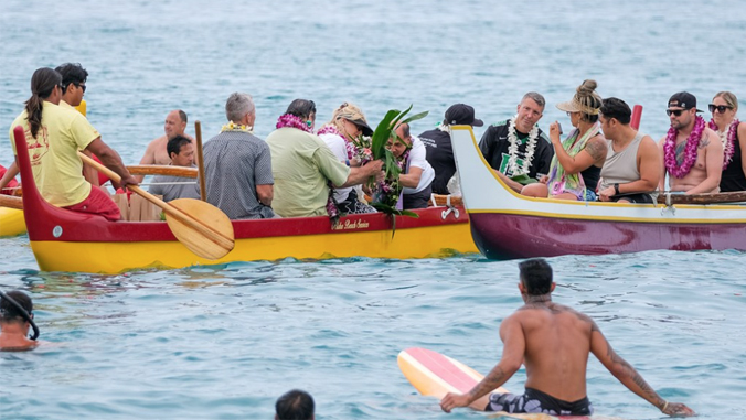 people paddling out on canoe