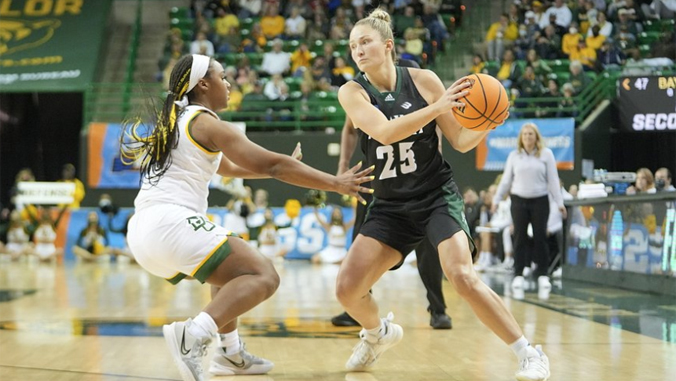 person with a basketball being guarded by another person