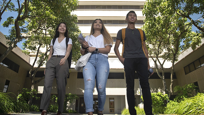 three students smiling