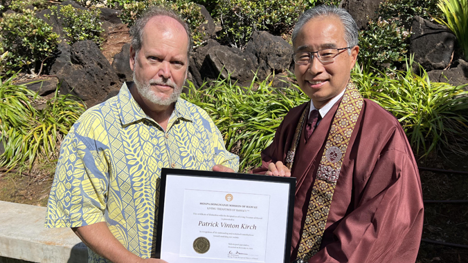 two people holding up a certificate