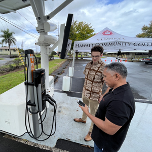 two men by charging station