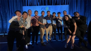 people standing on a stage with a trophy