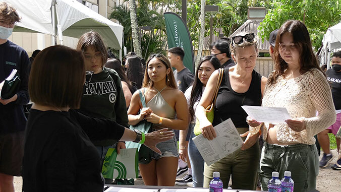 prospective students at booths