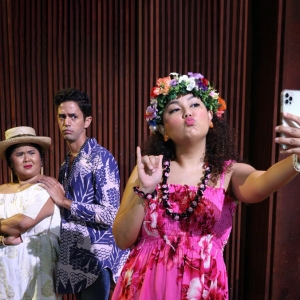 Two people looking at a third person taking a selfie