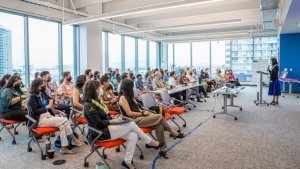 people looking at a person at a podium