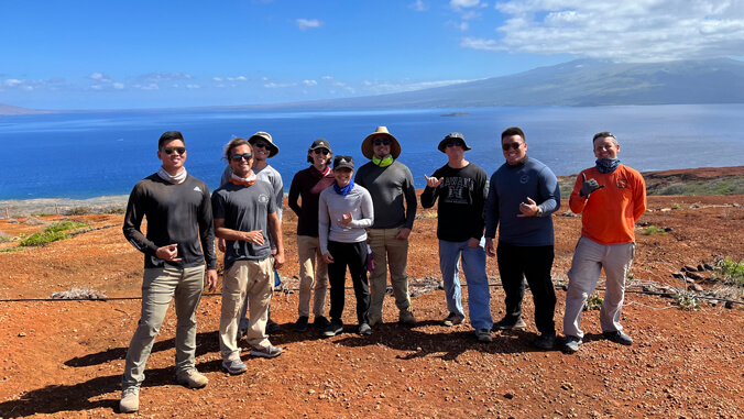 people on an island smiling for the photo