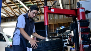 Student working on a tire