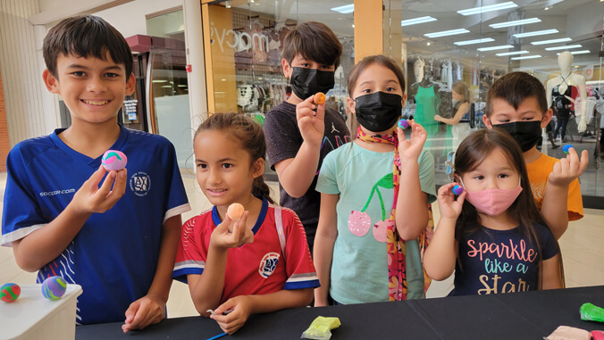 Keiki holding colorful clay balls