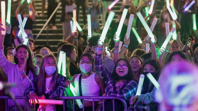 people with green light sticks 