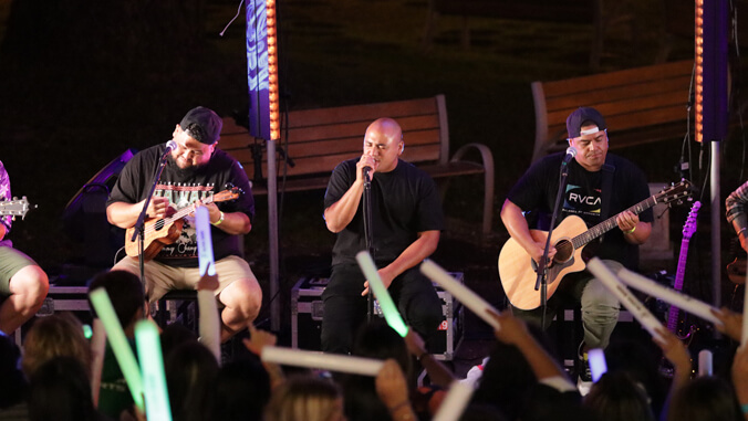 people sitting on a stage with a microphone