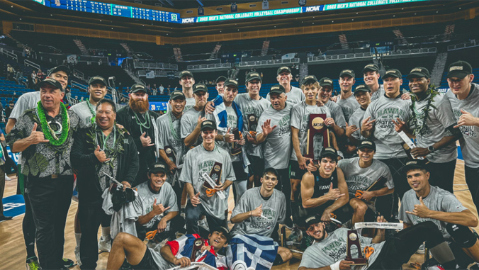 people in gray shirts with a large trophy