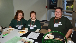 three people at a table smiling