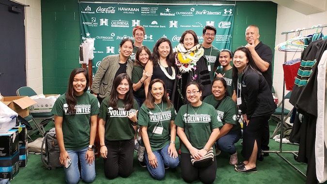 group of people in green shirts