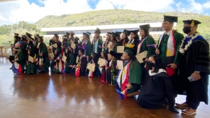 people in caps and gowns standing for a photo
