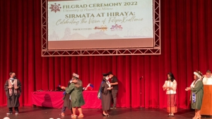people in caps and gowns on a stage
