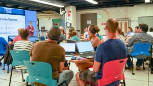 People with laptops watching a lecture