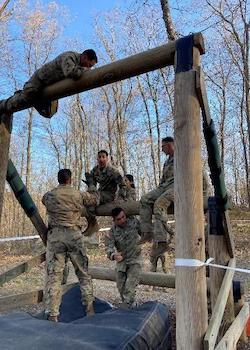 cadets climbing an obstacle