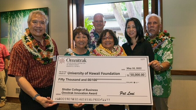 people standing holding a check