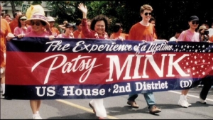 Patsy Mink in parade with a signal