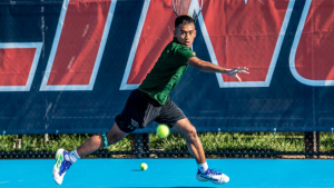 person with a tennis racket hitting a ball