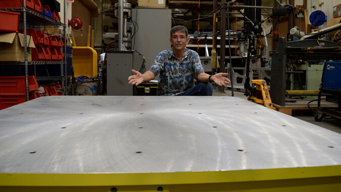 person standing behind a metal table