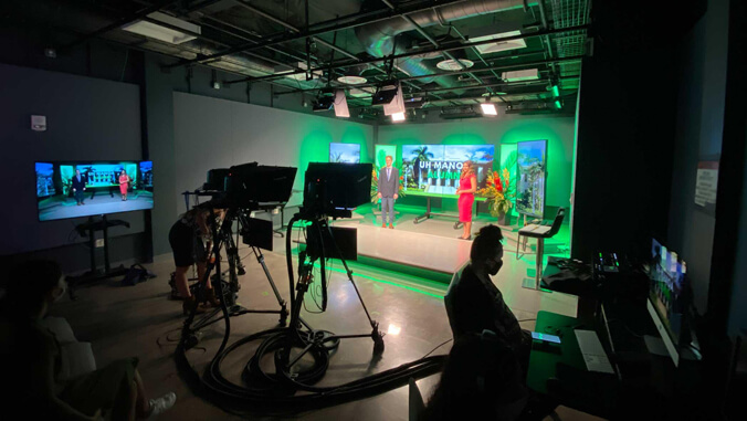 news set and cameras with two people standing