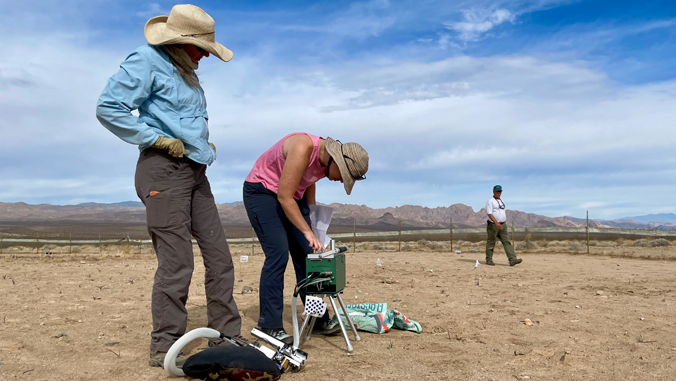 people performing research in a desert
