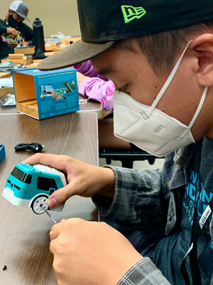 student working on electronic car