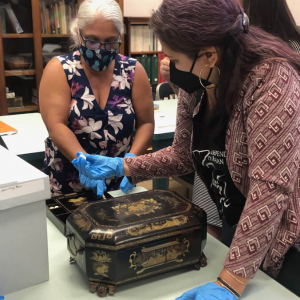 People working on a sewing box