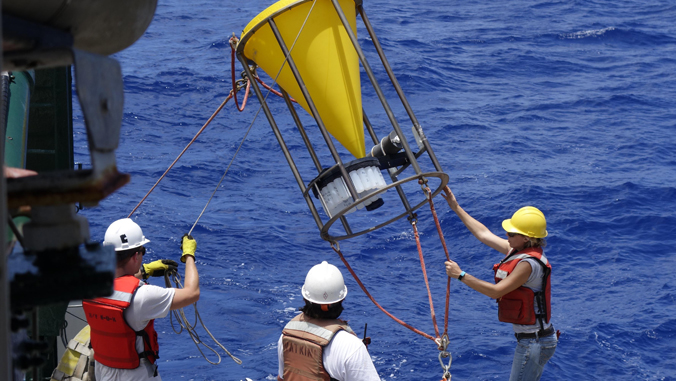 people holding instrument on boat