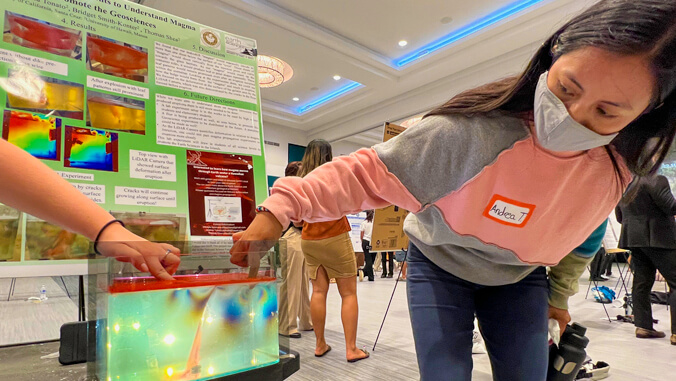 person placing hand in bright green display