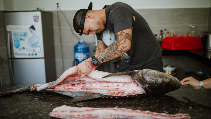 Person cutting fish