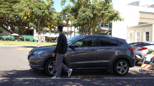 Person walking near parked cars close to campus center