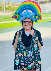 person with a balloon hat with a black tote bag