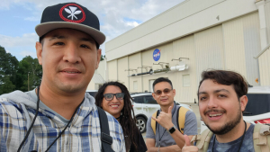 Four people outside a NASA facility