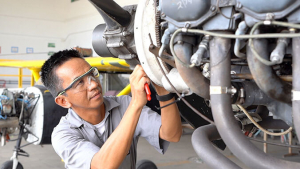 male working on airplane part