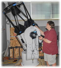 Astronomer working with telescope