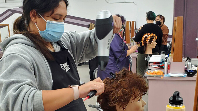 student work on hair mannequin