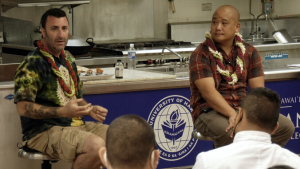 Two people addressing a class