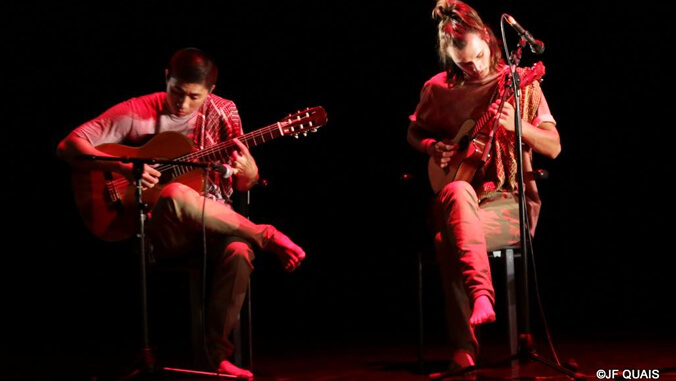 Two people playing guitar